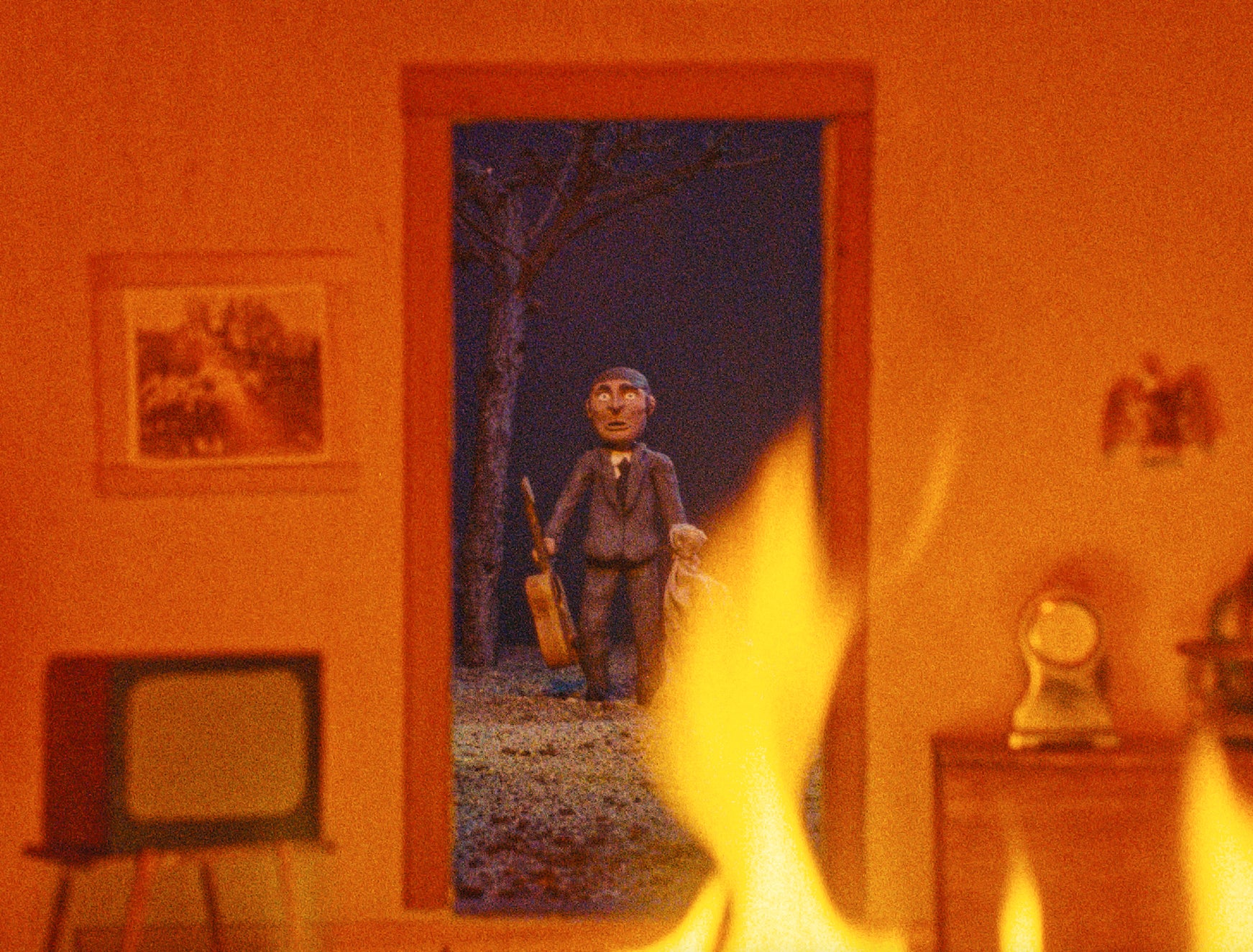 Figure standing in a doorway with a fiery foreground