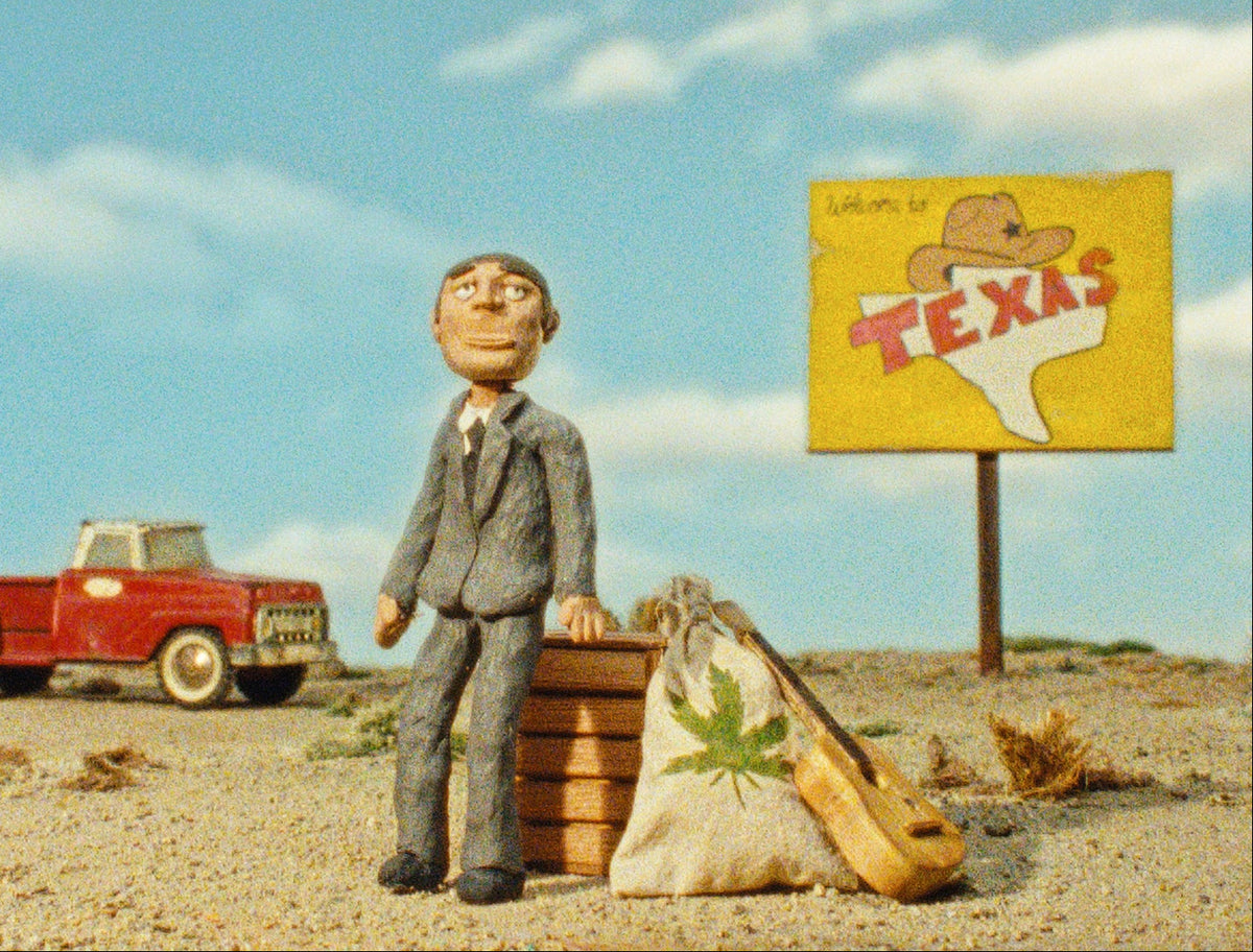 Animated character in a suit standing next to a red truck and 'Texas' sign in a desert setting.